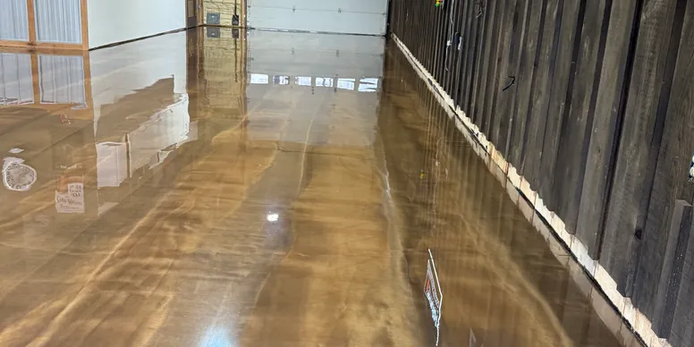 Metallic epoxy floor with rich amber and pearl swirls in a commercial interior