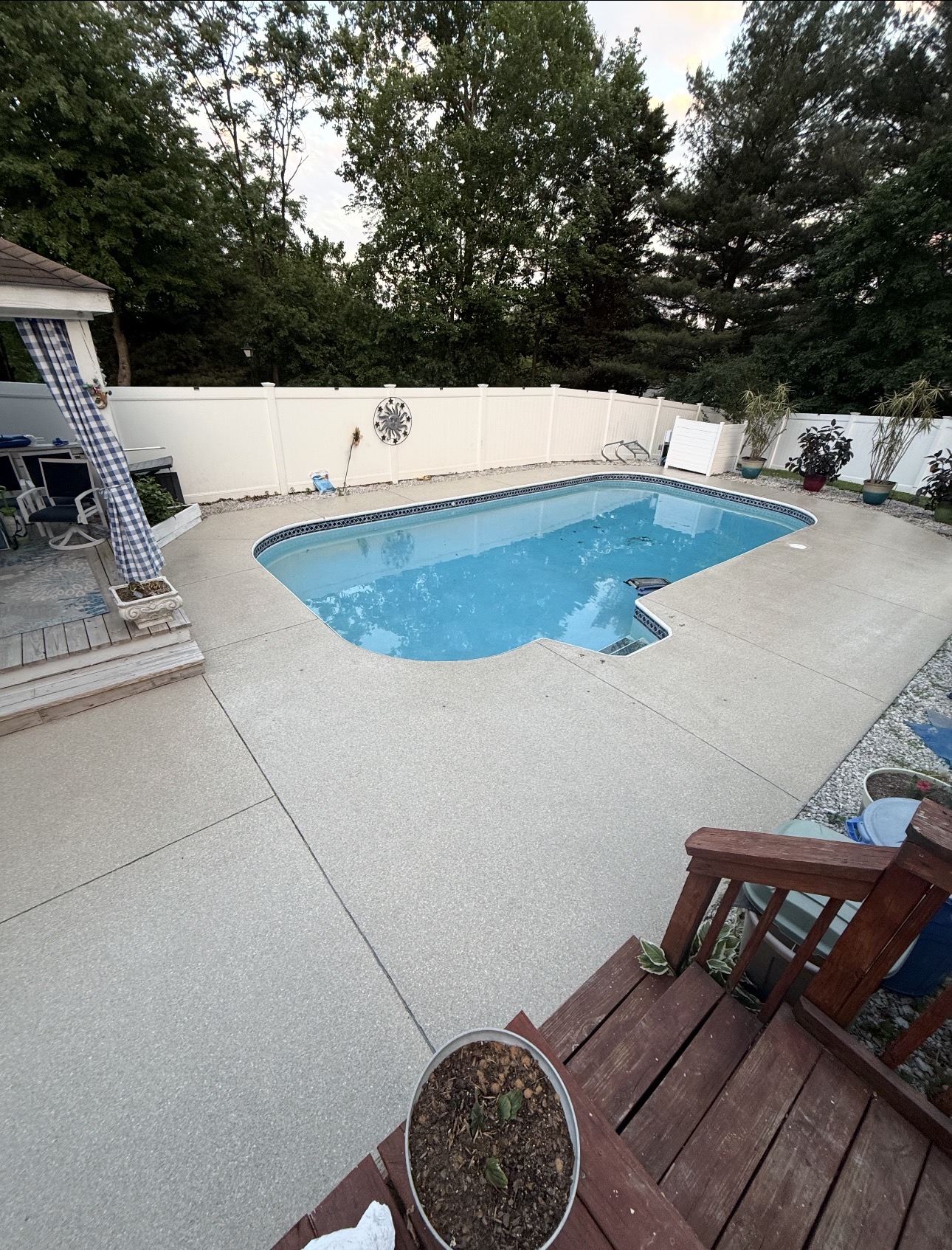 Light decorative flake coating surrounding a residential swimming pool