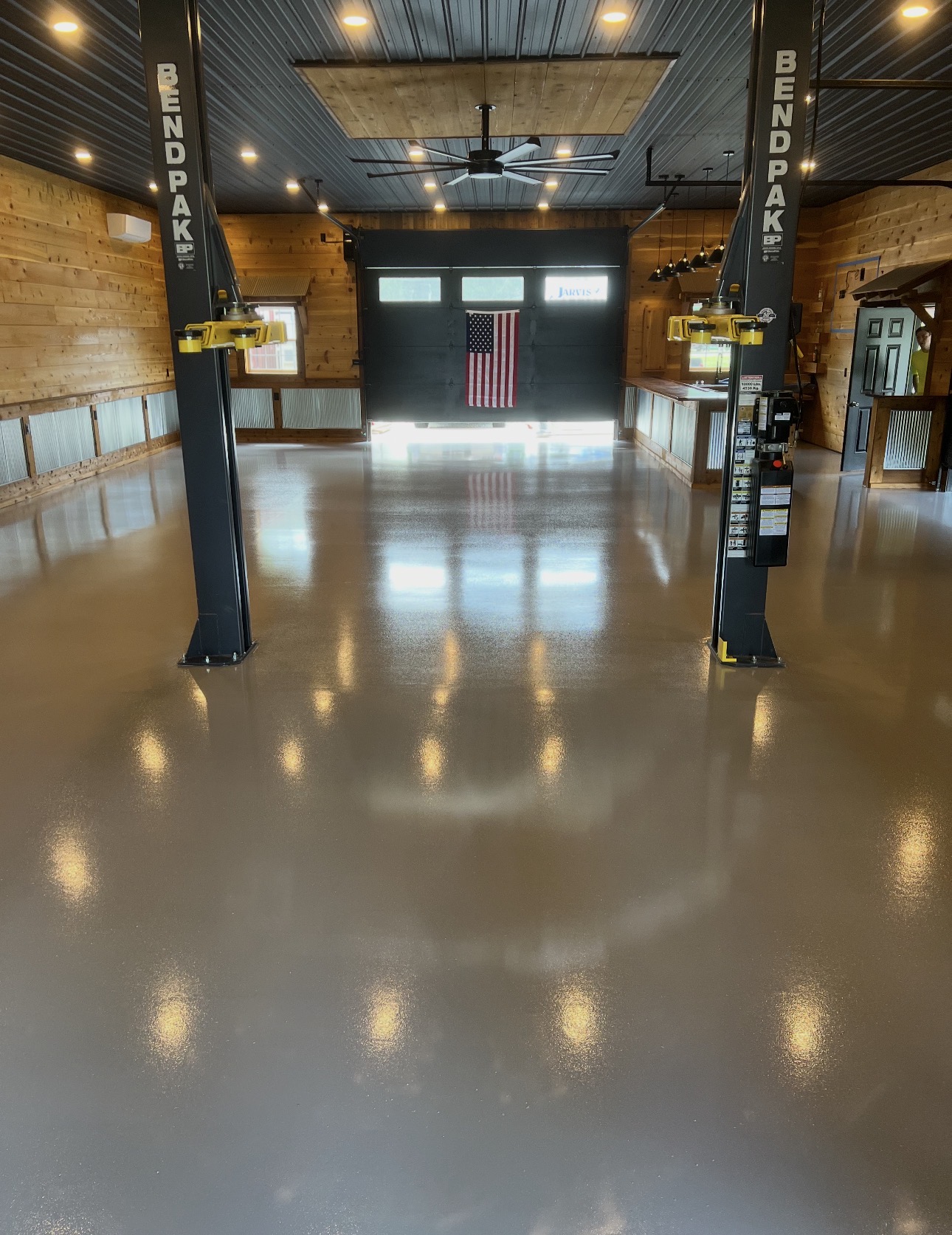 Glossy solid-color floor coating in a finished automotive shop