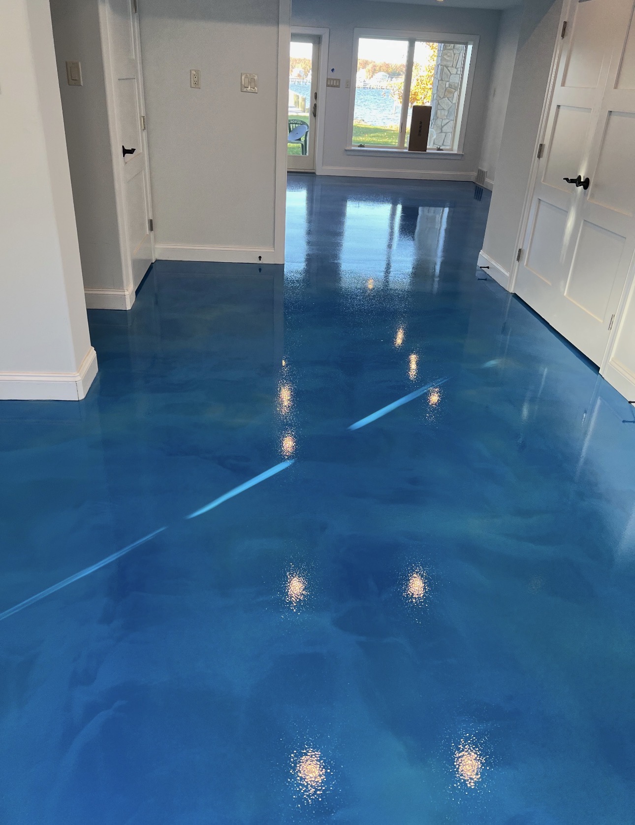 High-gloss blue epoxy floor in a residential interior
