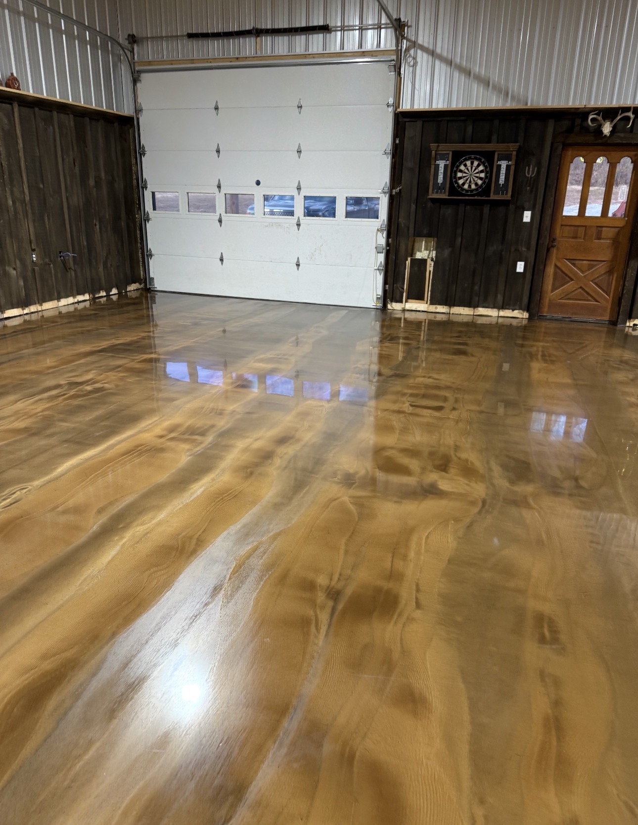 Gold and bronze metallic epoxy floor reflecting garage lighting