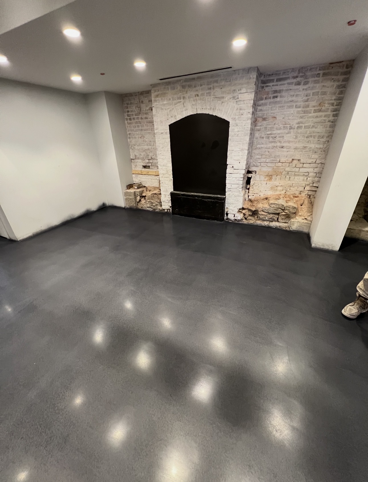 Dark slate metallic coating in a renovated space with exposed brick