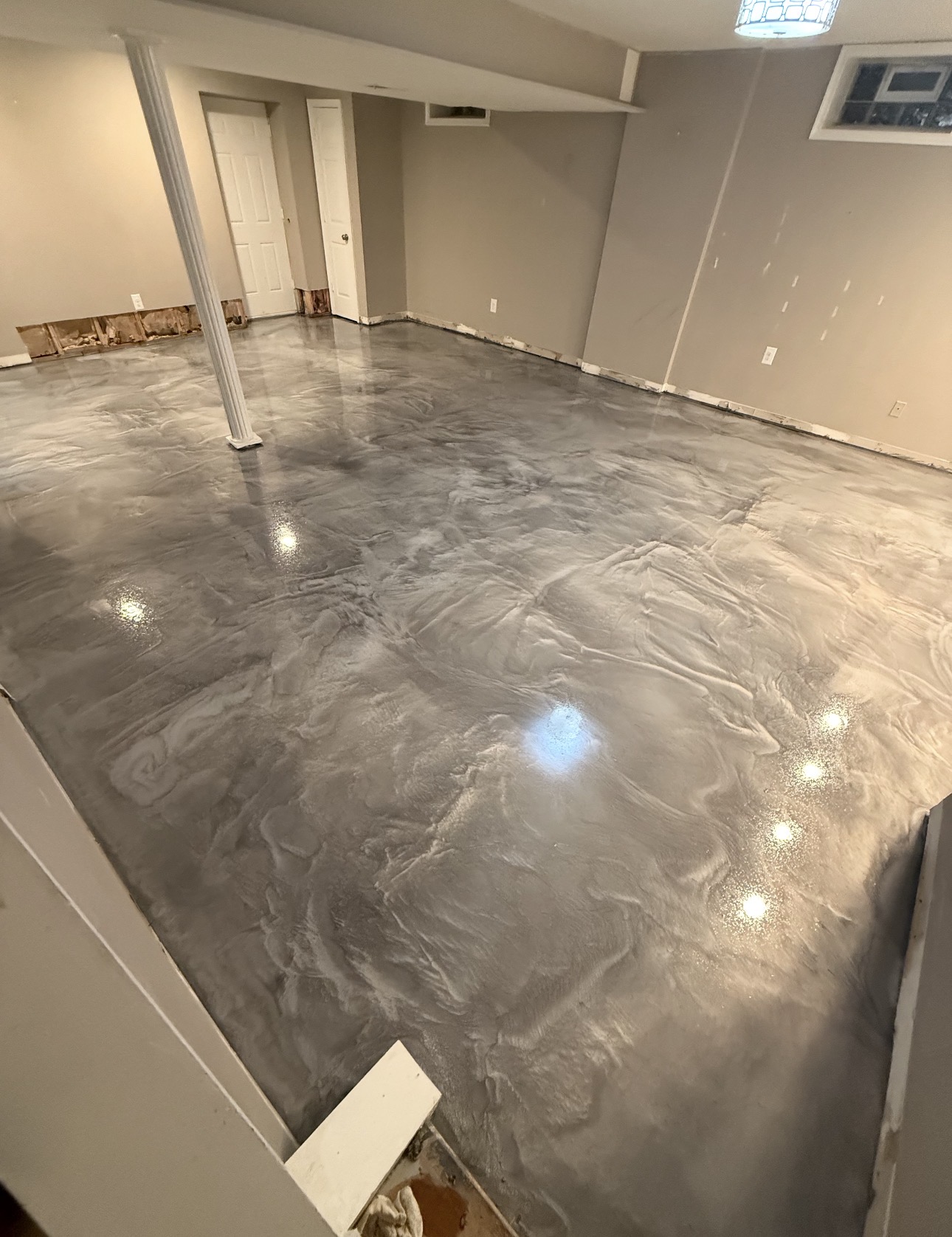 Silver and charcoal metallic epoxy floor with flowing marbled movement