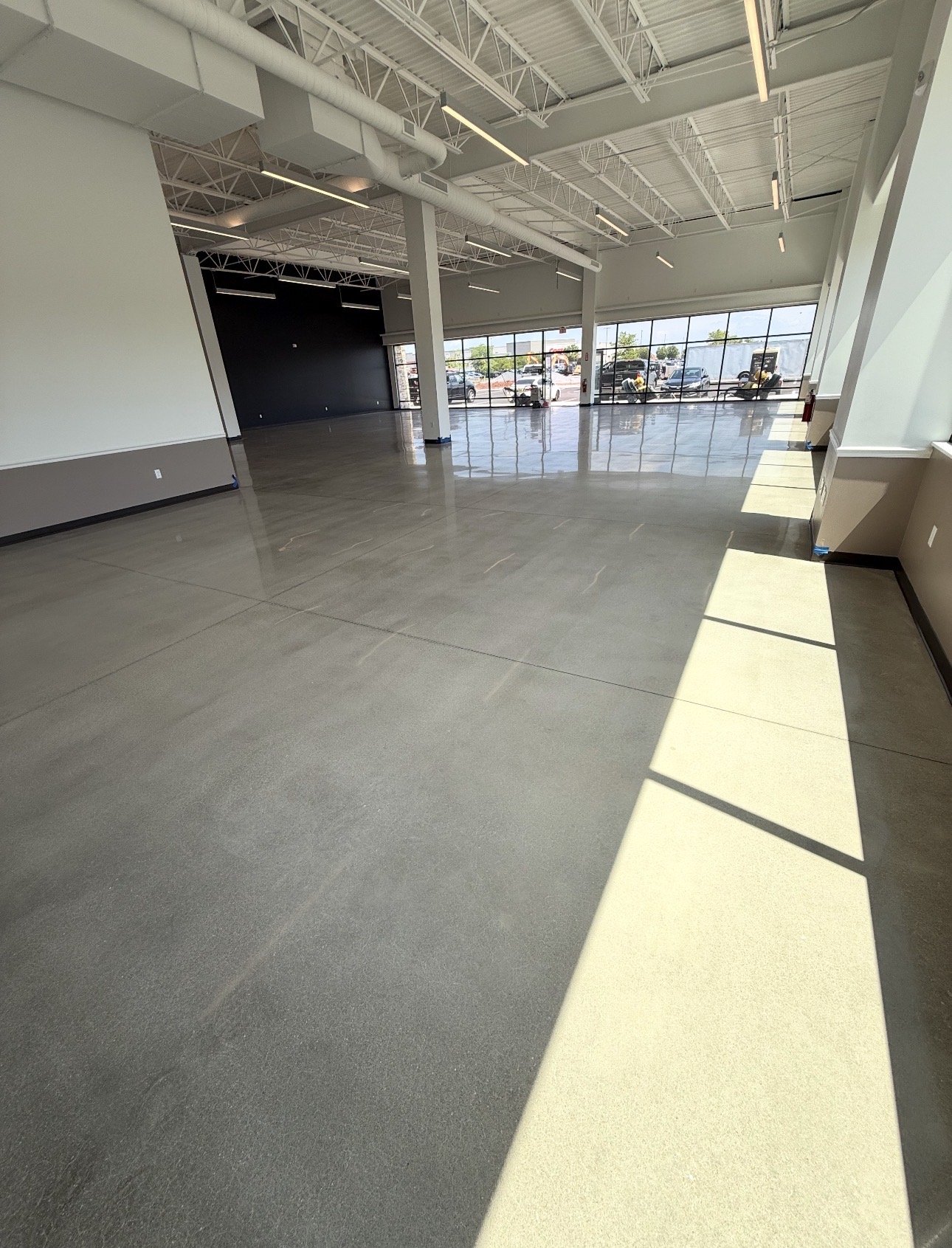 Gray polished concrete showroom floor in a new commercial build