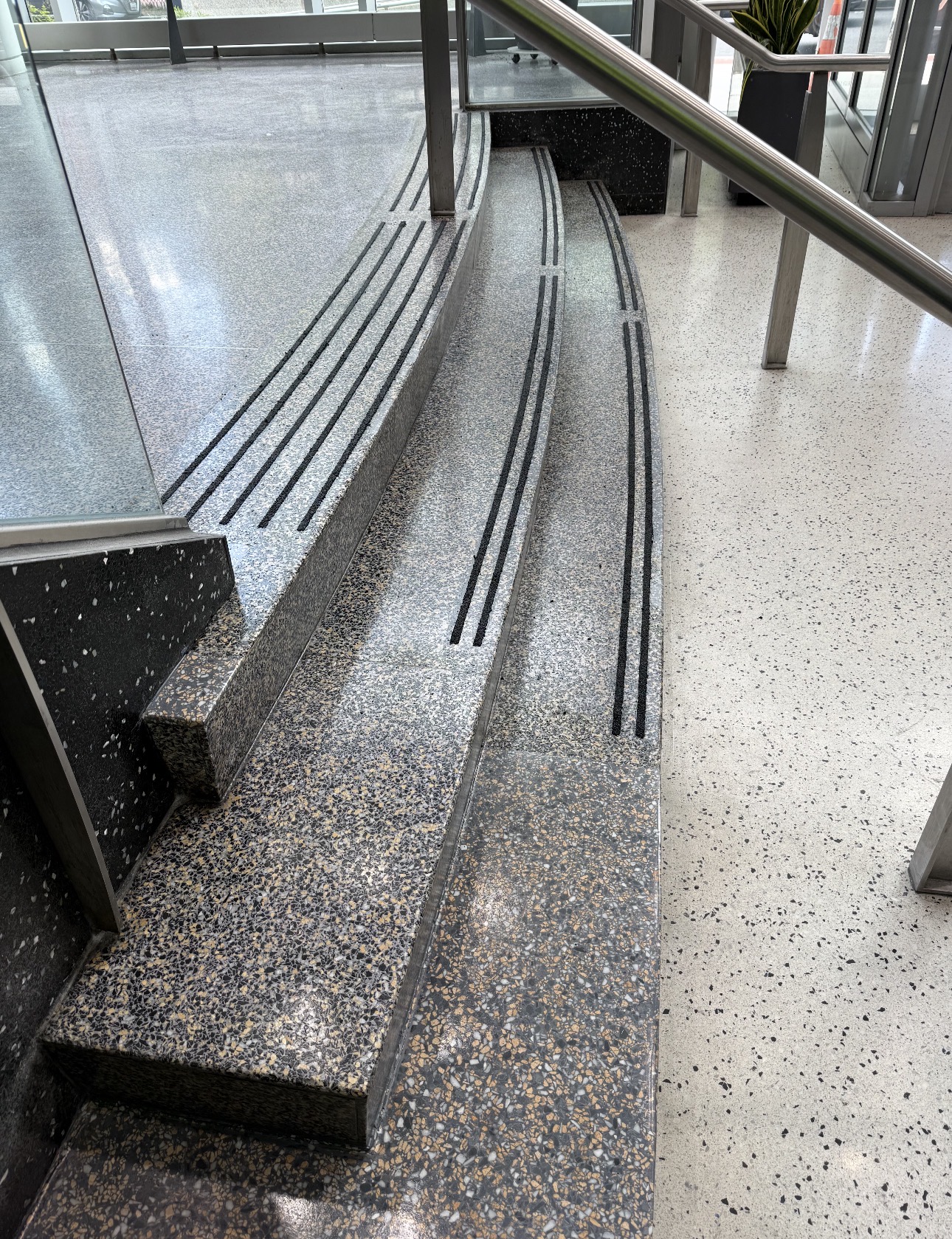 Multi-color terrazzo steps and landing with dark traction strips