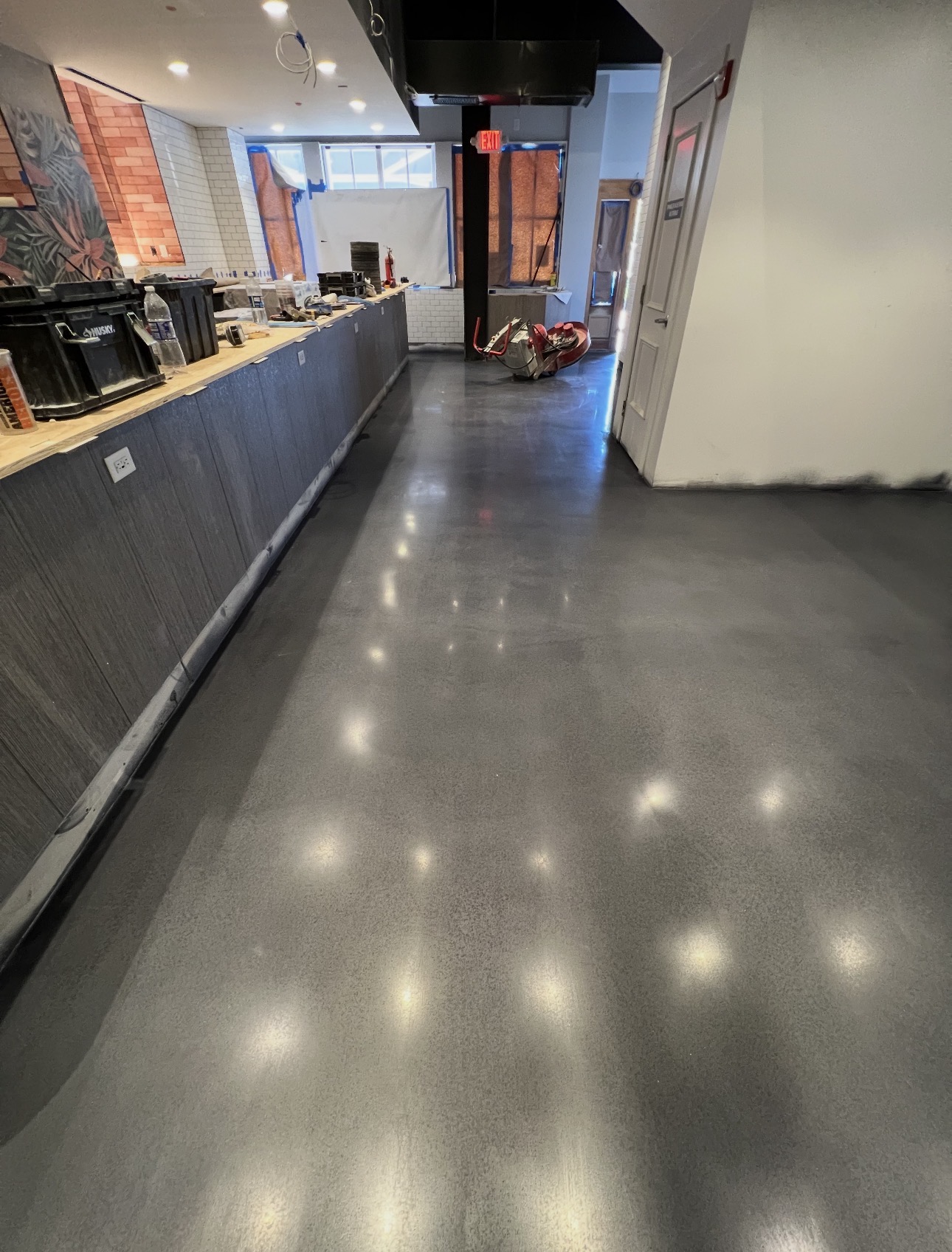 Dark gray polished concrete floor along a restaurant service counter
